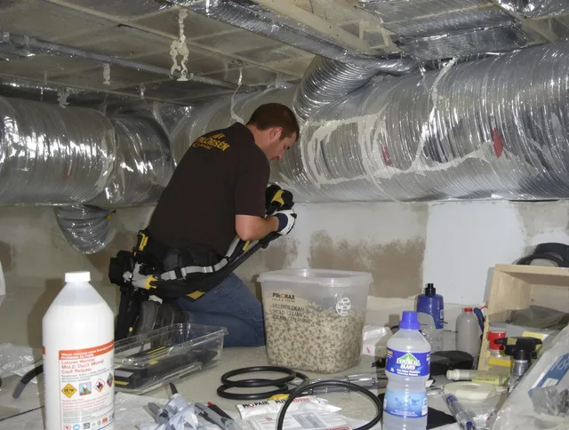 Swansea Air Duct Cleaning specialist performing professional mold removal from air ducts in Swansea