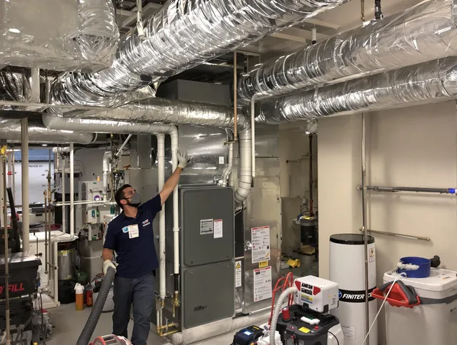 Swansea Air Duct Cleaning specialist performing thorough furnace duct cleaning in a Swansea residence