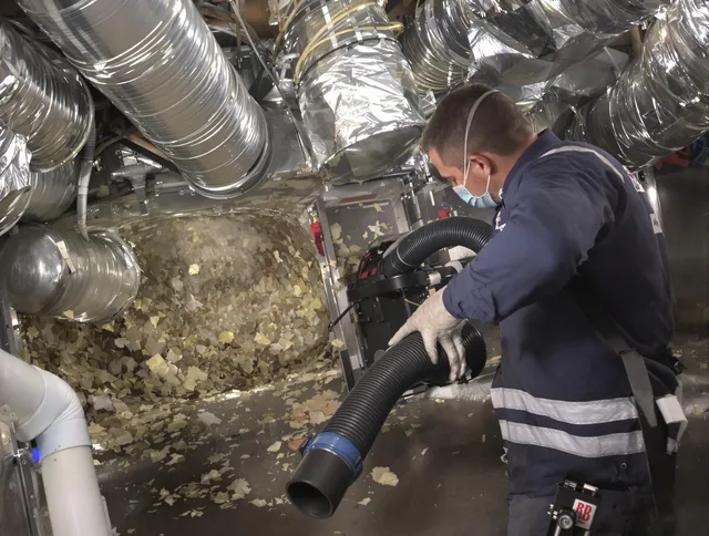 Swansea Air Duct Cleaning specialist operating negative pressure cleaning equipment for thorough duct maintenance in Swansea
