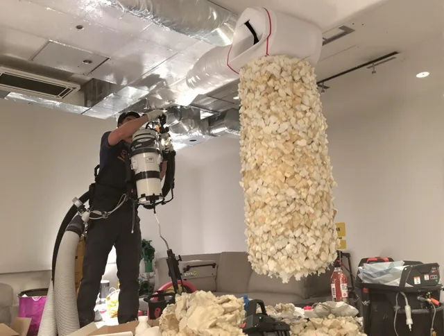 Swansea Air Duct Cleaning technician performing precision vacuum insulation removal in a residential property in Swansea